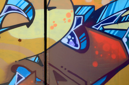 街头艺术。在米色和橙色色调的彩色涂鸦画片断的抽象背景图像