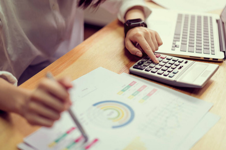 女实业家在办公室和使用计算机和计算器来执行财务会计.