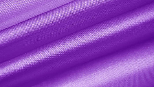 美丽的紫色背景的光织物。抽象背景