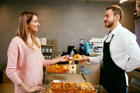 糕点。店里的女人选择新鲜的面包店