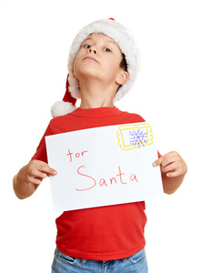 冬季假期圣诞节概念   带给圣诞老人的信，对分离出的白色帽子的男孩