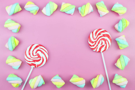 平躺顶视图美味开胃的概念, 极小的甜处理漩涡糖果棒糖软糖彩色图案粉红色粉彩背景和复制空间