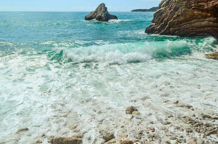 海浪海沫在海岸的石头上断裂