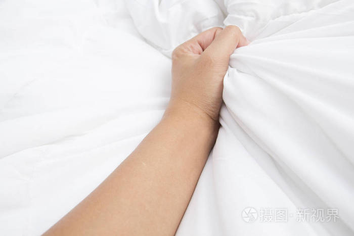妇女在狂喜之中拉白色床单的手