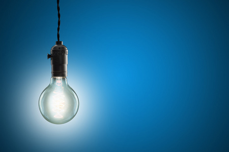 思想观念 — — 老式白炽灯泡在蓝色背景照片