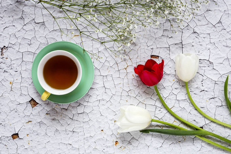 杯茶，用红色和白色郁金香花卉背景和