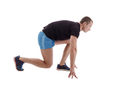 侧面图的赛跑者在起跑线上照片