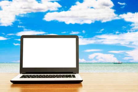 桌面上有空白屏幕的笔记本电脑, 美丽的海背景, 旅游理念