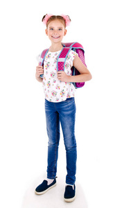 微笑愉快的学校女孩的画像与书包背包和书隔绝在白色背景教育概念