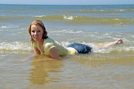 美丽的金发女人在水里放松
