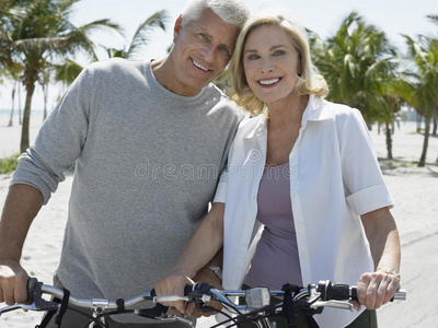 热带海滩上骑自行车的幸福夫妻