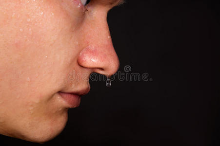 头盔里的那个人那个年轻人在出汗,鼻子里滴水照片