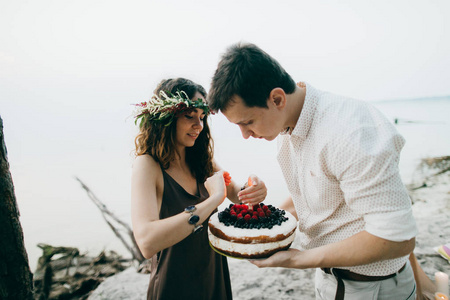 快乐美丽的年轻夫妇举行蛋糕