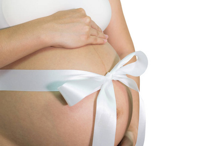 孕妇手抱腹部带白丝带礼物, 健康概念, 与拷贝空间隔绝白色背景