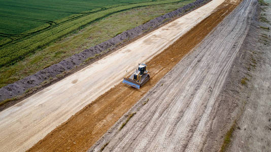 法国反铲装载机和道路工程压路机的空中照片