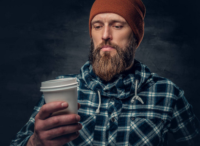 大胡子的男人握杯咖啡