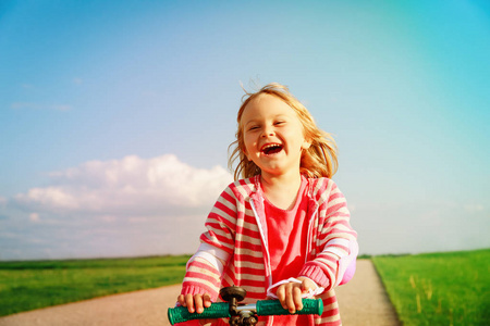 夏天快乐的小女孩骑摩托车