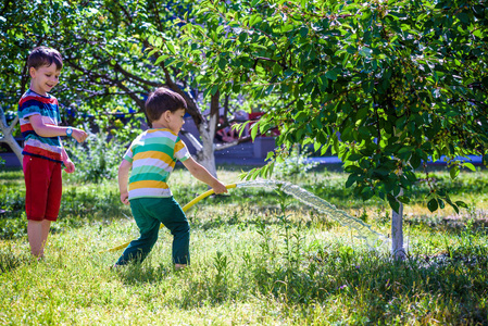 孩子, 可爱的金发小男孩, 浇水的植物, 美丽的苹果树, 从软管喷雾在