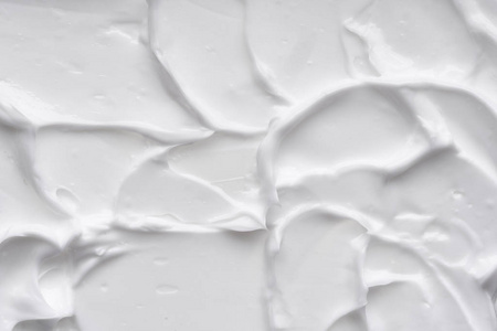 白色的 reamy 纹理被隔离在白色背景上。白底面霜涂抹