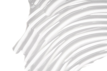 粉红色面霜柔和的粉红色奶油纹理在白色背景下分离.白底面霜涂抹照片