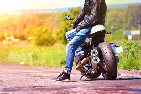 美丽的背景与摩托车司机和他的摩托车在旅行中