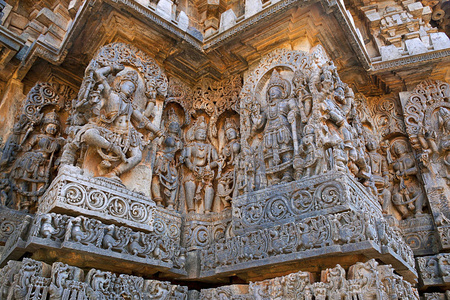 雕塑西侧墙壁。湿婆在左边和毗湿奴在右边。Hoysaleshwara 寺, Halebidu, 卡纳卡, 印度。从西边看