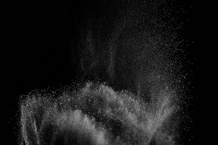 冻结在黑色背景上的白色粒子的运动。粉末爆炸。抽象的灰尘覆盖纹理