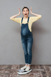 意外怀孕美女站在体重秤上照片