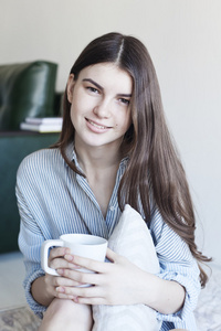 年轻女人在早上喝茶