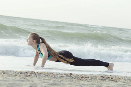 女孩在海滩上俯卧撑, 背景波浪