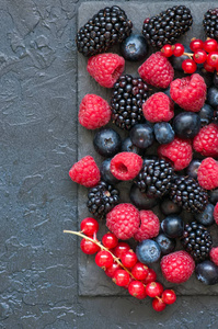 浆果覆盆子红醋栗和蓝莓在黑色的混合