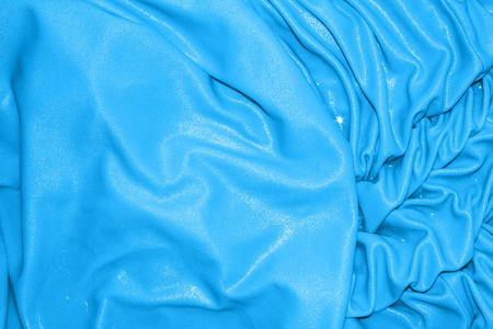 蓝色明亮的丝绸背景。蓝色丝绸纹理