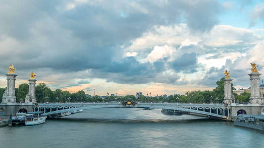 亚历山大三世大桥横跨河围网游戏中时光倒流。装饰着华丽的艺术灯具和雕塑。查看从荣军院桥。巴黎。法国。蓝多云的天空，在日落之前