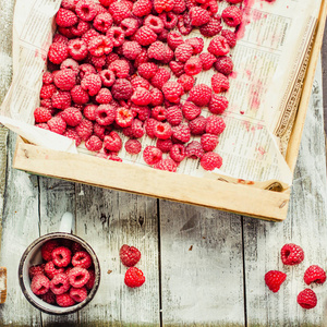 红莓在蓝色木桌上的盒子里。新鲜的浆果。排毒饮食和夏日饮食观念。Instagram 尺寸