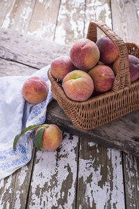 新鲜成熟的多汁有机天然水果在一个木质旧的背景。篮子里的熟桃子从花园里收获的水果