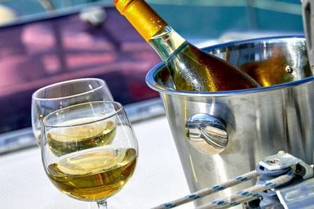 游艇上的白葡萄酒瓶酒杯和水桶