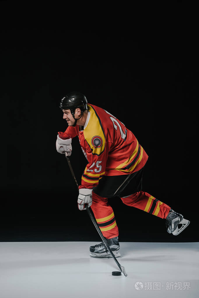 冰球运动员的侧面观看曲棍球和看黑