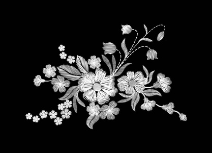 野花上黑色背景上的绣花白色野花照片