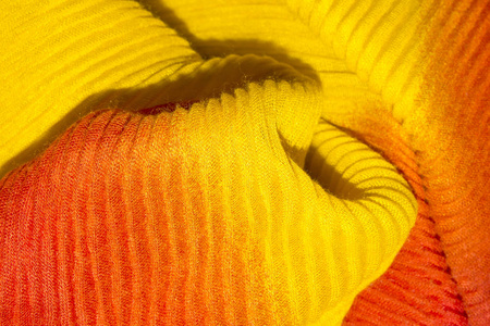 黄色橙色波纹织物背景。黄橙色波纹织物纹理
