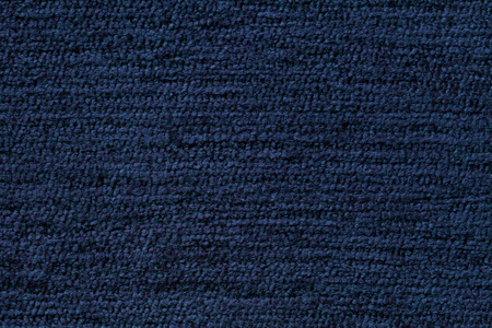 从柔软的纺织材料的深蓝色背景。织物的天然纹理