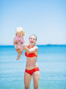 快乐妈妈在沙滩上和宝宝玩耍