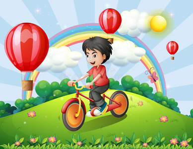 一个男孩骑着彩虹和漂浮的气球在山顶上骑车
