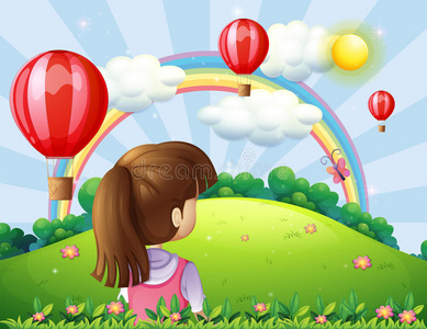 一位年轻的女士看着漂浮的气球和彩虹