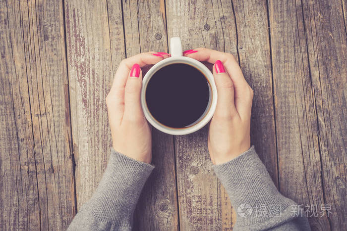 手持咖啡杯的女性手顶部视图