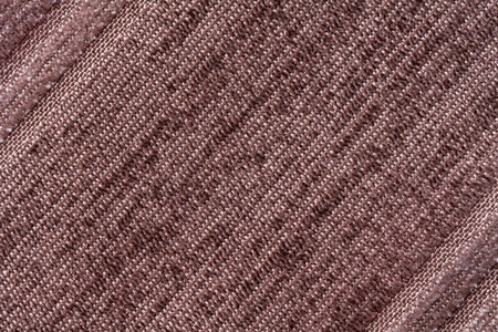 棕色背景下一种针织的纺织材料。织物的条纹的纹理特写