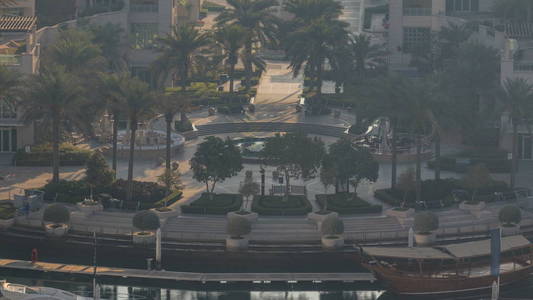 迪拜码头喷泉上午 timelapse, 港口与豪华游艇和滨海长廊, 迪拜, 阿拉伯联合酋长国。日出时的薄雾, 手掌和道路上的交通