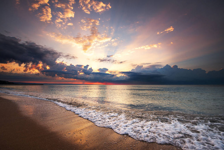 南茂宜日出丰富多彩的海洋海滩日出与深蓝色的天空和太阳的光芒照片