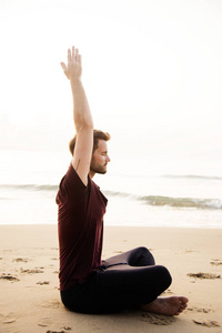 练瑜伽在海滩上的人