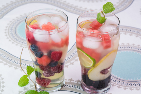 眼镜的水果和浆果，薄荷注入水与冰
