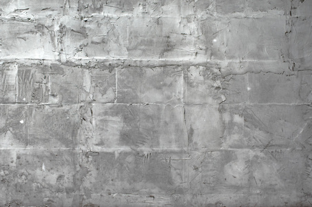 白色的风化的石膏墙背景